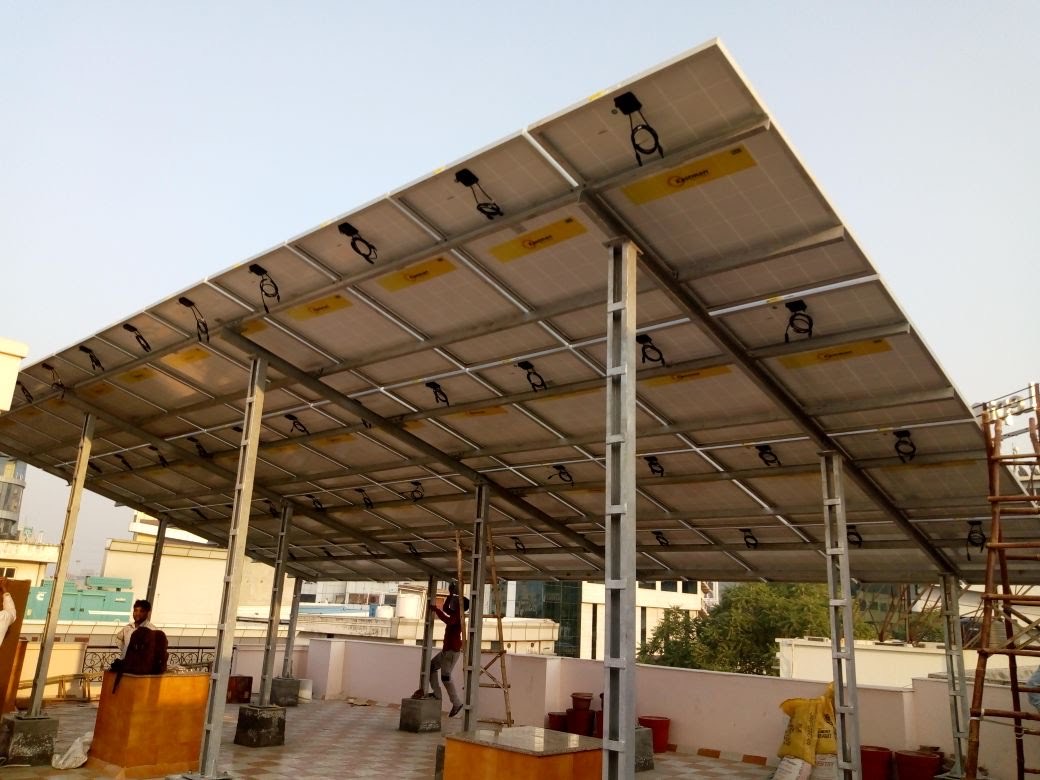 Installers fitting panels on an elevated solar structure above a home terrace