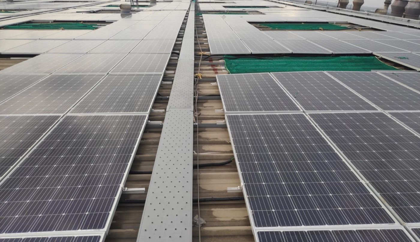 Rooftop solar plant with a service walkway on a factory shed